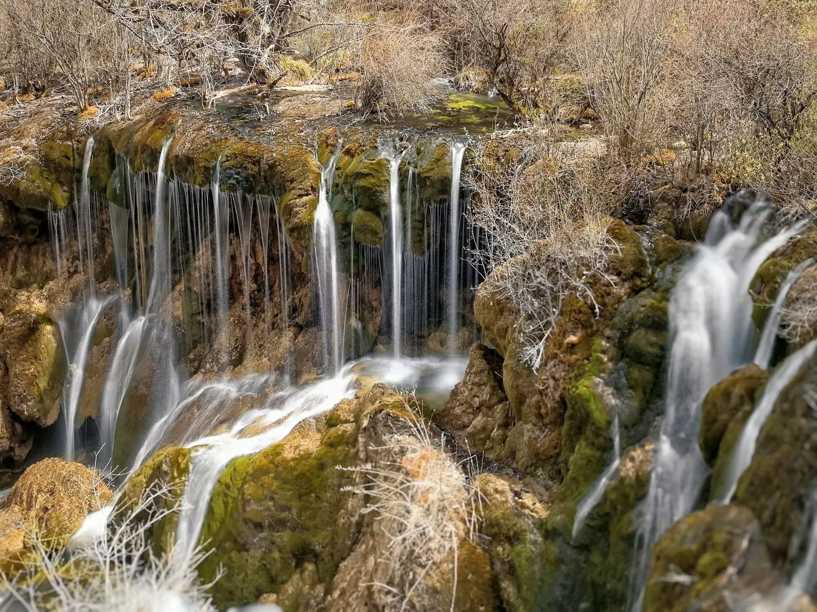 Waterfall and colorful forest scenery in Jiuzhaigou Valley, Sichuan